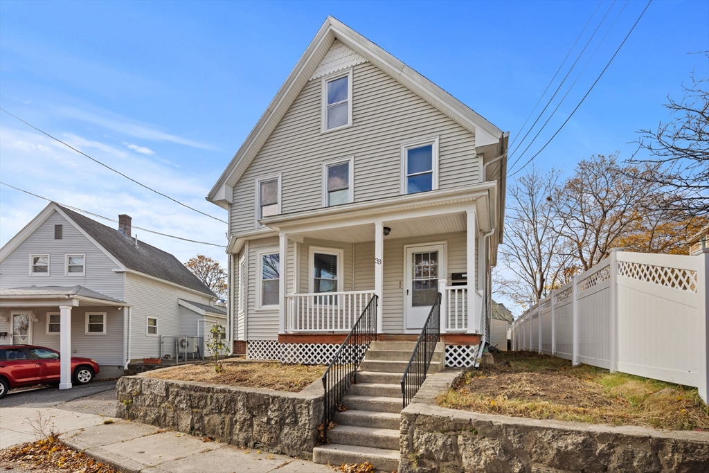 33 Chestnut Street Milford, MA 01757 - Photo 2 of 41 a front view of a house with a yard
