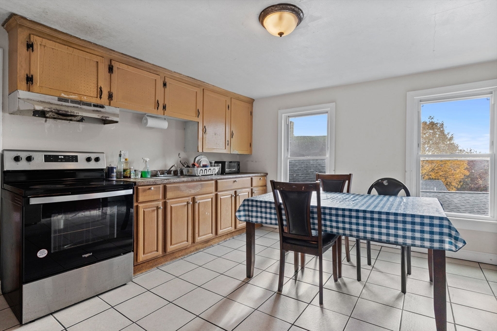 33 Chestnut Street Milford, MA 01757 - Photo 21 of 41 a kitchen with a dining table and chairs