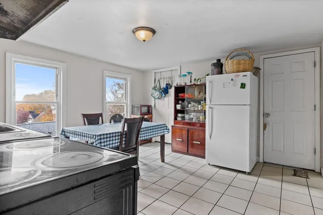 a living room with furniture and a dining table
