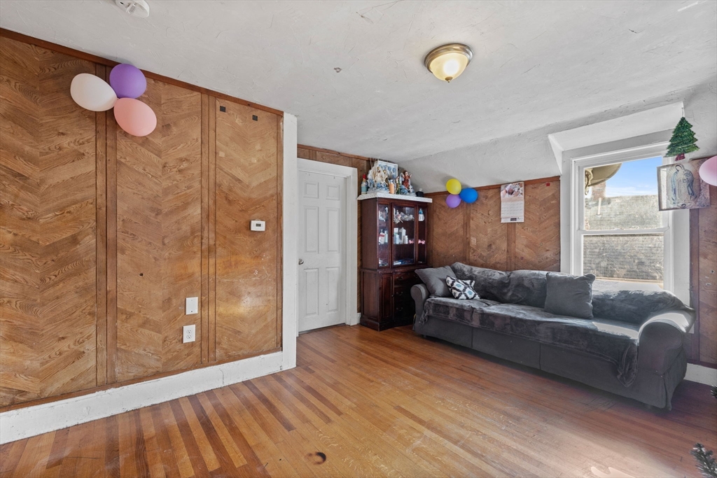 33 Chestnut Street Milford, MA 01757 - Photo 25 of 41 a living room with furniture and a large window