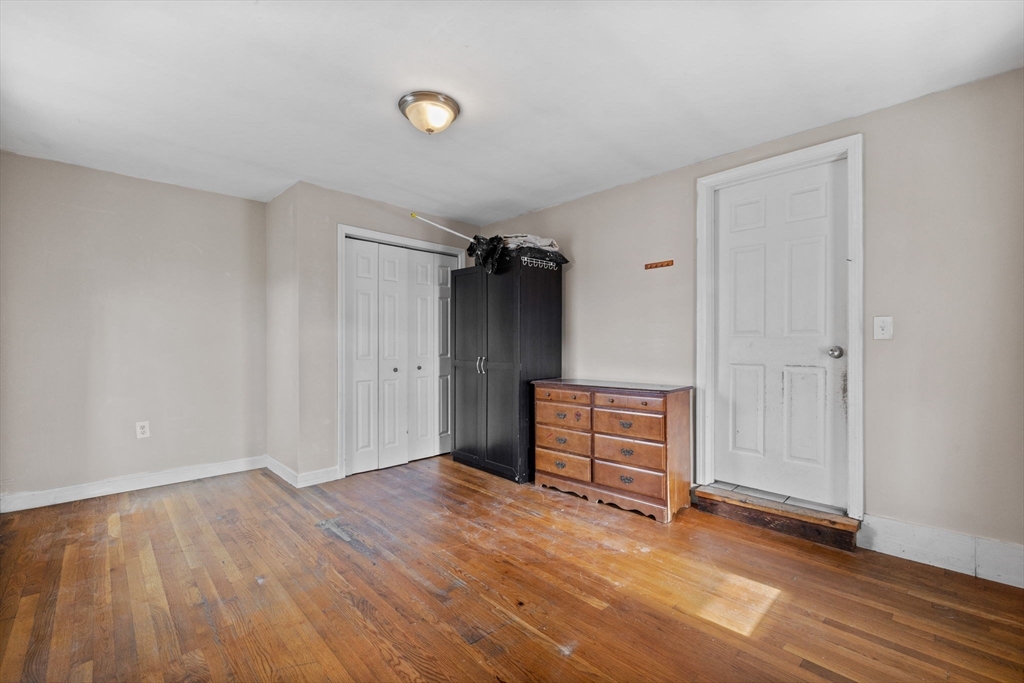 33 Chestnut Street Milford, MA 01757 - Photo 30 of 41 an empty room with wooden floor and cabinet