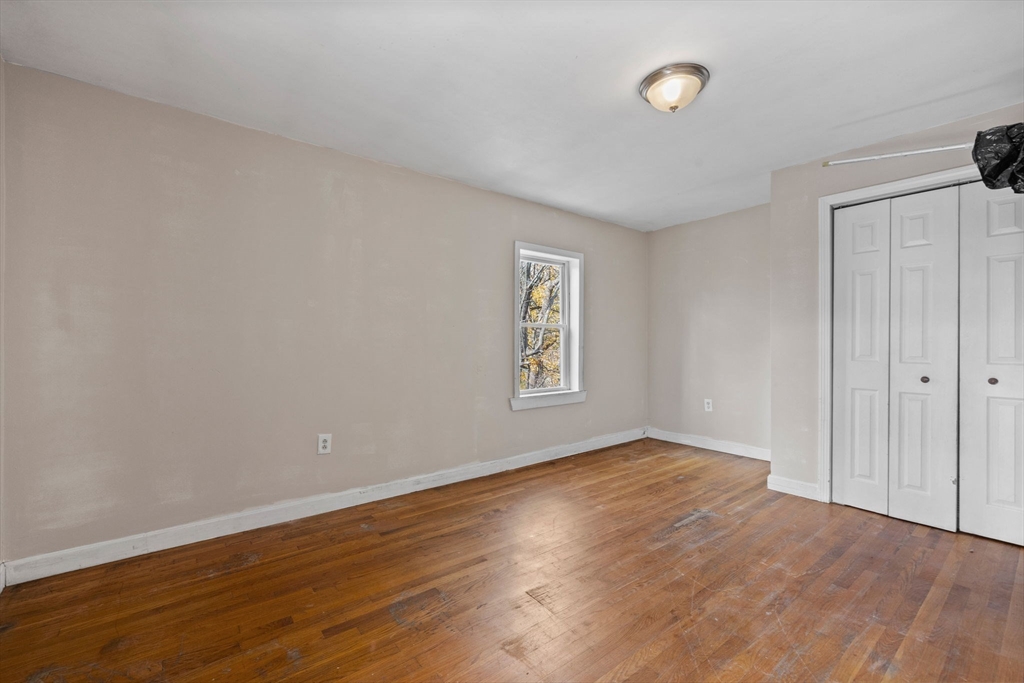 33 Chestnut Street Milford, MA 01757 - Photo 31 of 41 an empty room with wooden floor and windows
