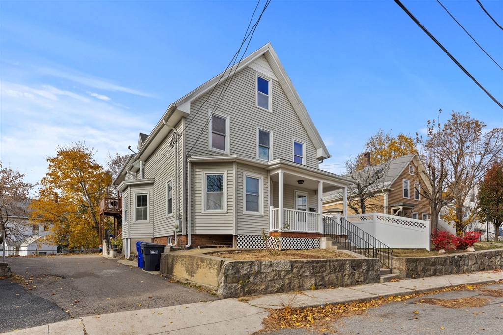 33 Chestnut Street Milford, MA 01757 - Photo 4 of 41 a front view of a house with a yard