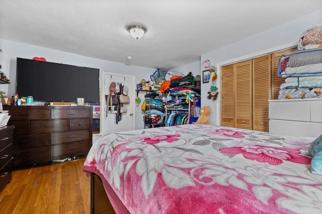 33 Chestnut Street Milford, MA 01757 - Photo 6 of 41 a bedroom with a bed and a flat screen tv