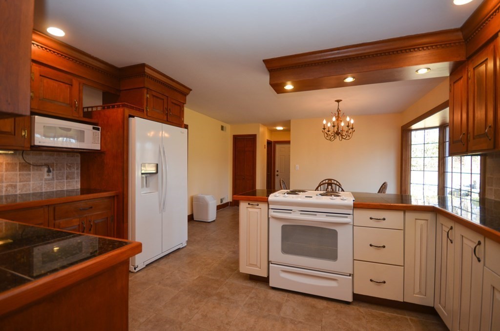 19 Butternut Drive Sutton, MA 01590 - Photo 11 of 33 a kitchen with a stove and a sink