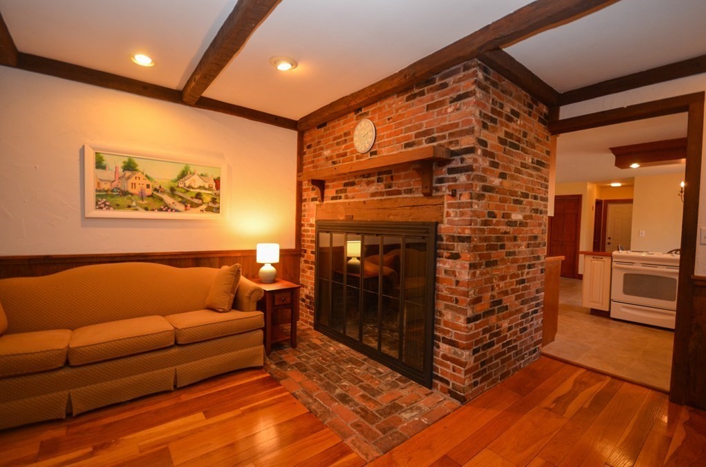 19 Butternut Drive Sutton, MA 01590 - Photo 16 of 33 a living room with furniture and a fireplace