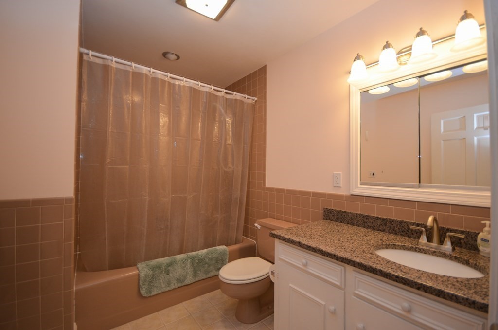 19 Butternut Drive Sutton, MA 01590 - Photo 20 of 33 a bathroom with a granite countertop sink a toilet and a mirror