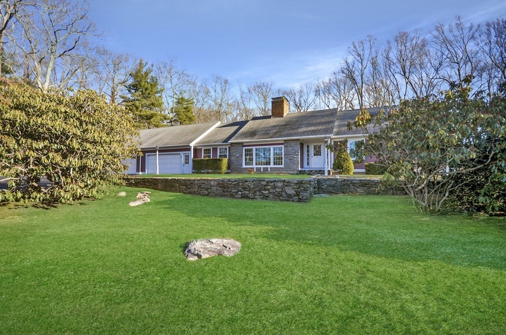19 Butternut Drive Sutton, MA 01590 - Photo 2 of 33 a front view of a house with a yard table and chairs