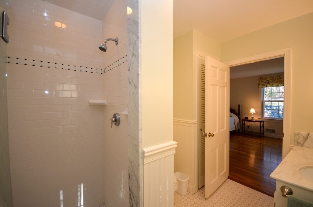 19 Butternut Drive Sutton, MA 01590 - Photo 25 of 33 a bathroom with a glass shower door