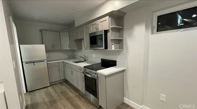 a kitchen with a refrigerator stove and microwave