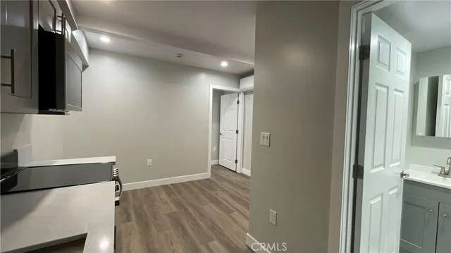 a view of a room with wooden floor and cabinet