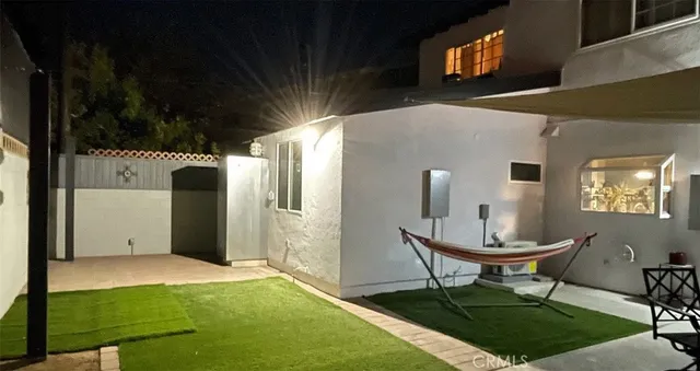 a view of a porch with a table and chairs