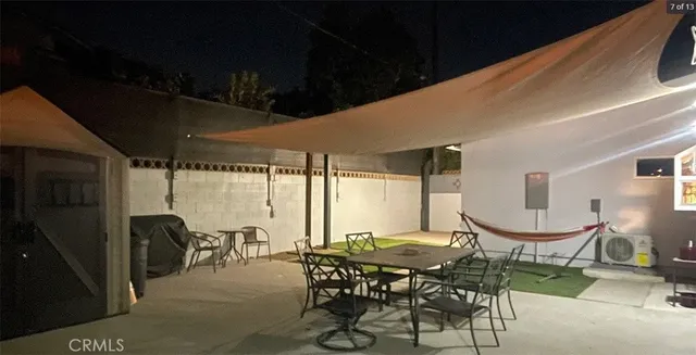 a view of a porch with chairs and backyard