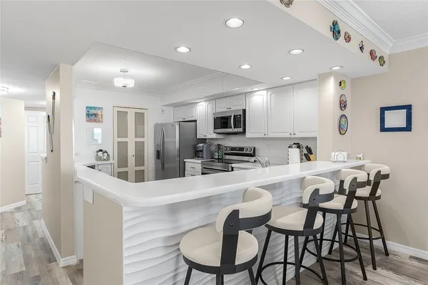 a large kitchen with a table and chairs