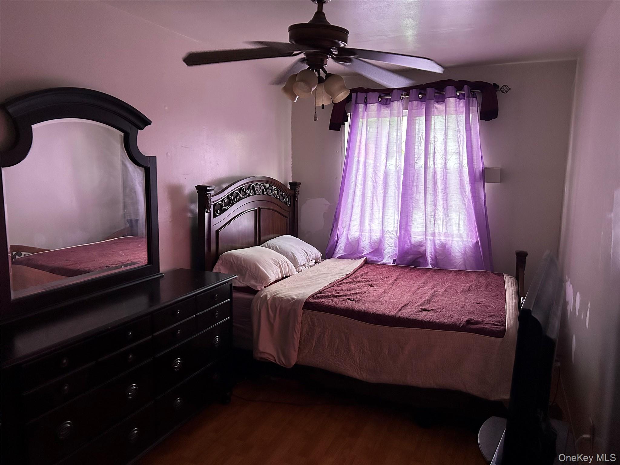 1285 Putnam Avenue Brooklyn, NY 11221 - Photo 5 of 8 Bedroom featuring dark wood-style flooring and ceiling fan