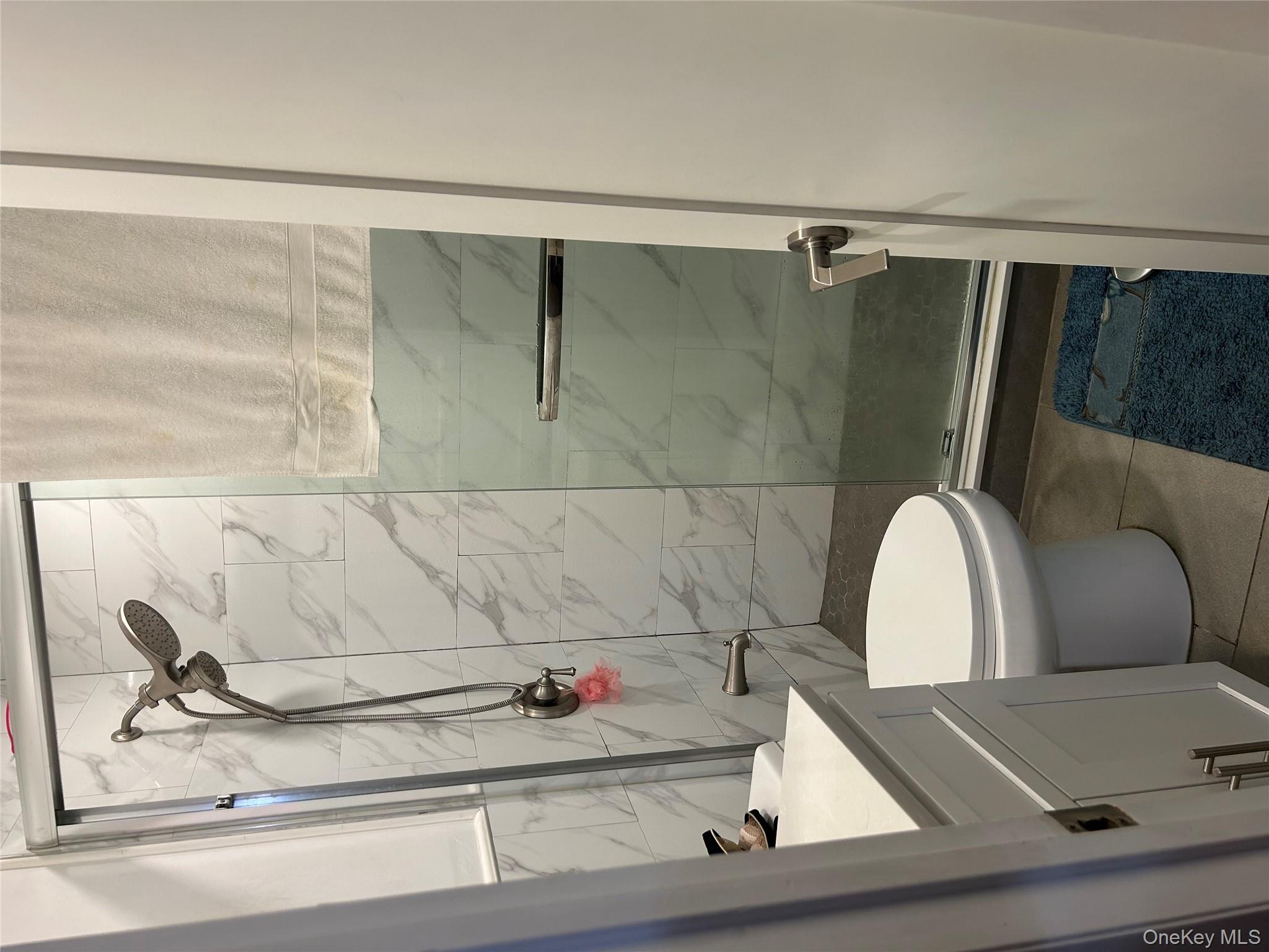 1285 Putnam Avenue Brooklyn, NY 11221 - Photo 7 of 8 Full bathroom with a shower stall, vanity, and light tile patterned floors