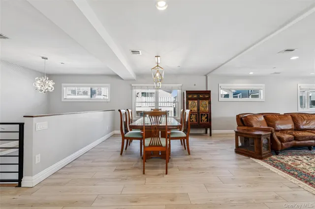 a living room with furniture a dining table and chairs with wooden floor