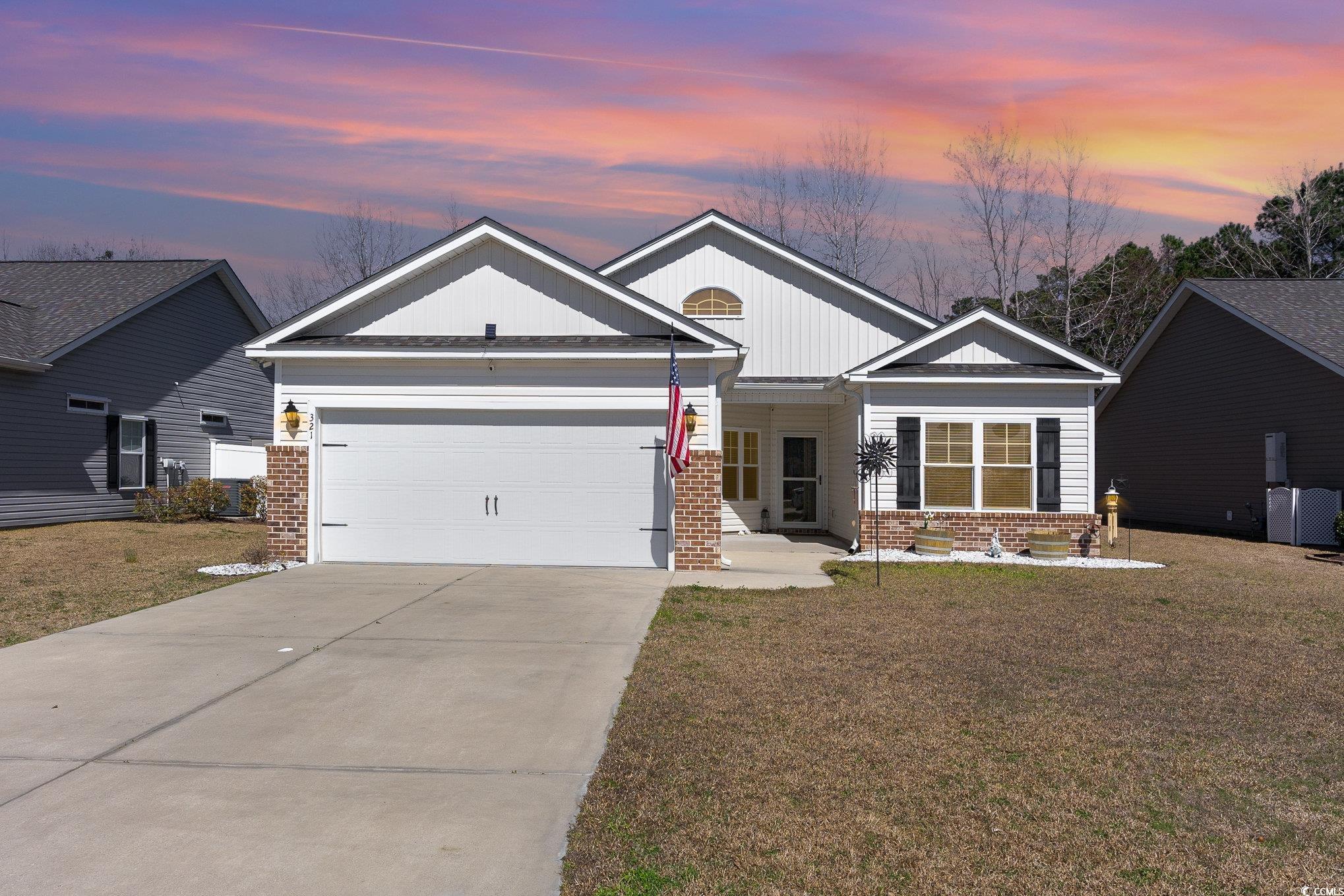 321 Cabo Loop Myrtle Beach, SC 29588 - Photo 1 of 25 View of front of home with a garage, a yard, and b