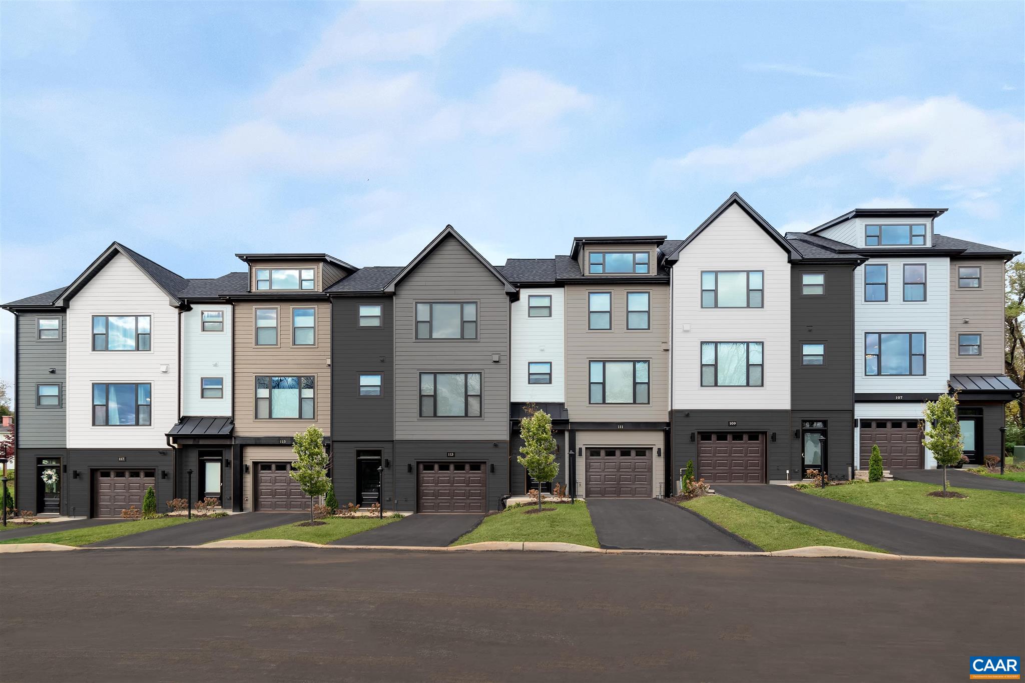 a front view of a residential apartment building with a yard