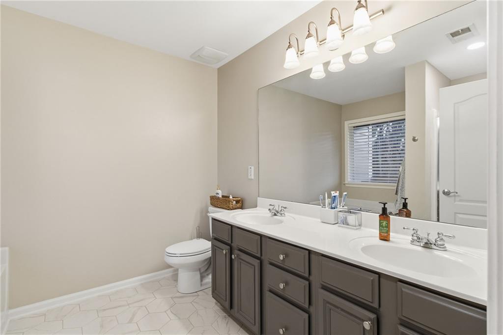 203 River Green Avenue Canton, GA 30114 - Photo 14 of 28 a bathroom with a double vanity sink mirror and toilet