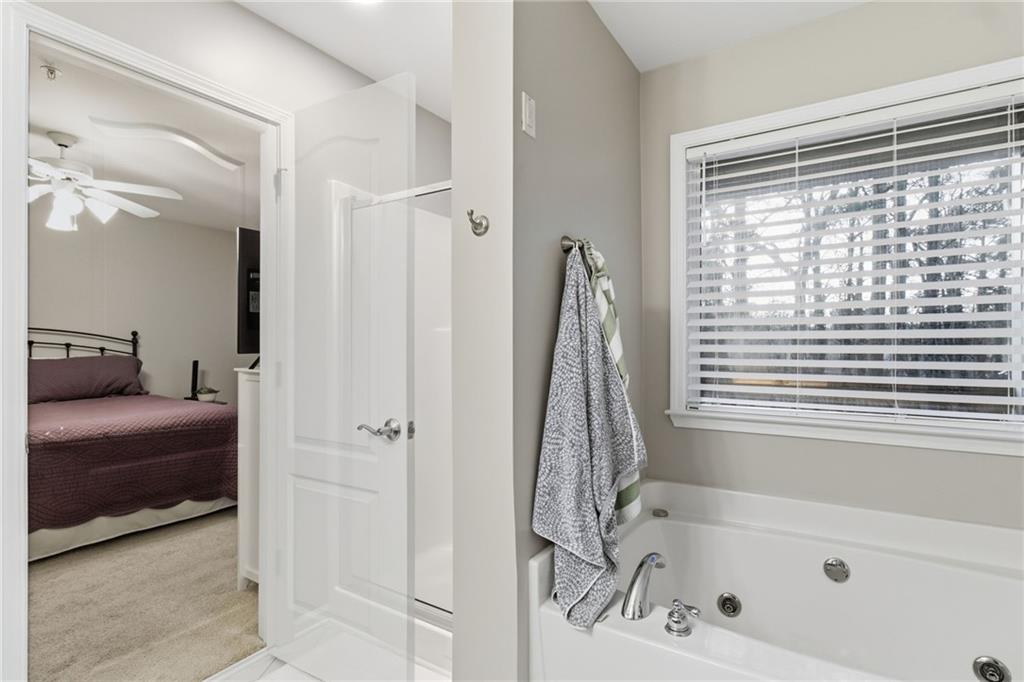 203 River Green Avenue Canton, GA 30114 - Photo 15 of 28 a bathroom with a tub shower and a sink