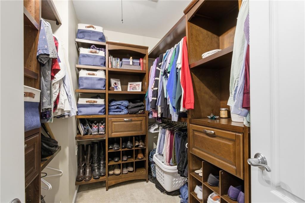 203 River Green Avenue Canton, GA 30114 - Photo 16 of 28 a view of walk in closet with clothes and shoes