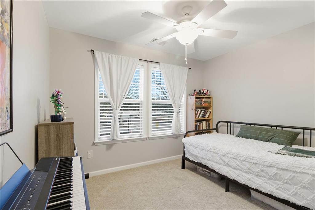 203 River Green Avenue Canton, GA 30114 - Photo 18 of 28 a bedroom with a bed and a window