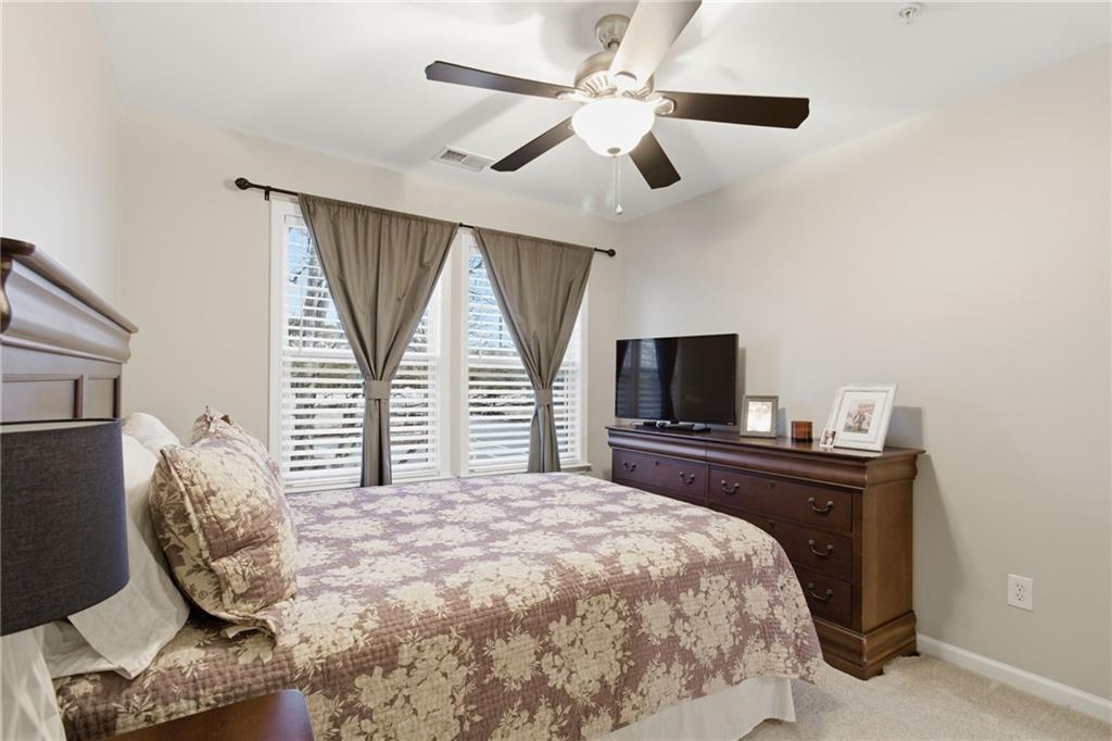 203 River Green Avenue Canton, GA 30114 - Photo 20 of 28 a bedroom with a bed and a flat screen tv