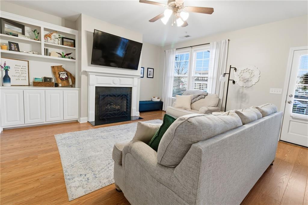 203 River Green Avenue Canton, GA 30114 - Photo 3 of 28 a living room with furniture a flat screen tv and a fireplace