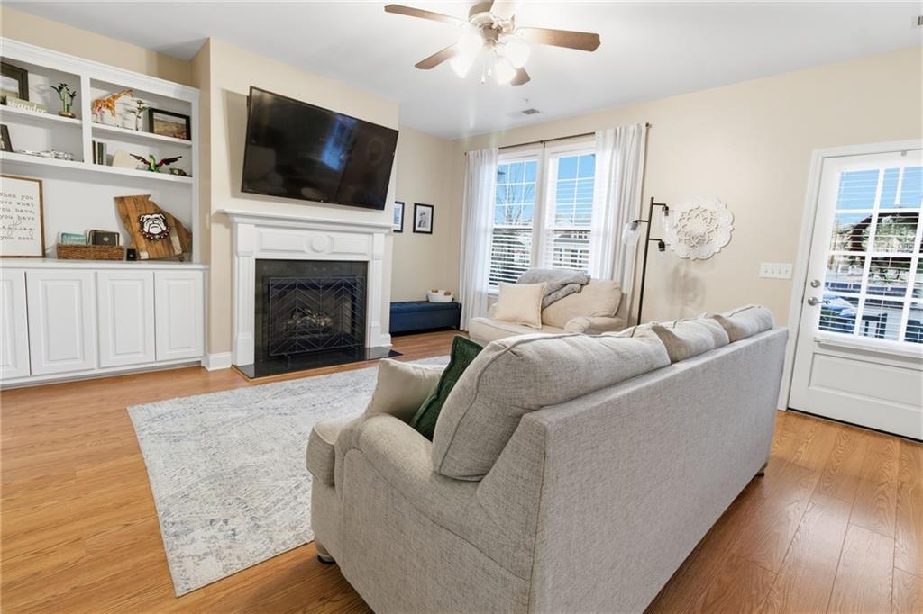 203 River Green Avenue Canton, GA 30114 - Photo 6 of 28 a living room with furniture a flat screen tv and a fireplace