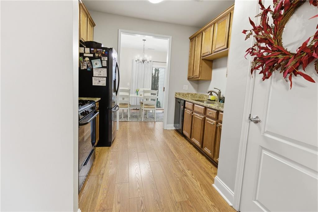 203 River Green Avenue Canton, GA 30114 - Photo 7 of 28 a kitchen with stainless steel appliances granite countertop a refrigerator and a stove top oven