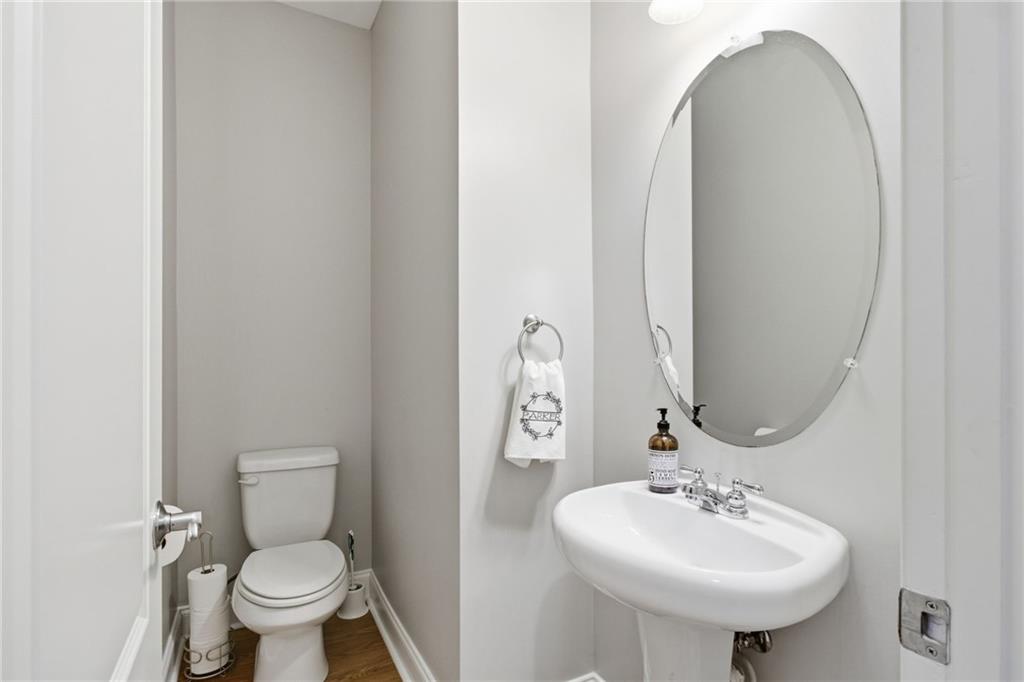 203 River Green Avenue Canton, GA 30114 - Photo 10 of 28 a bathroom with a toilet sink and mirror