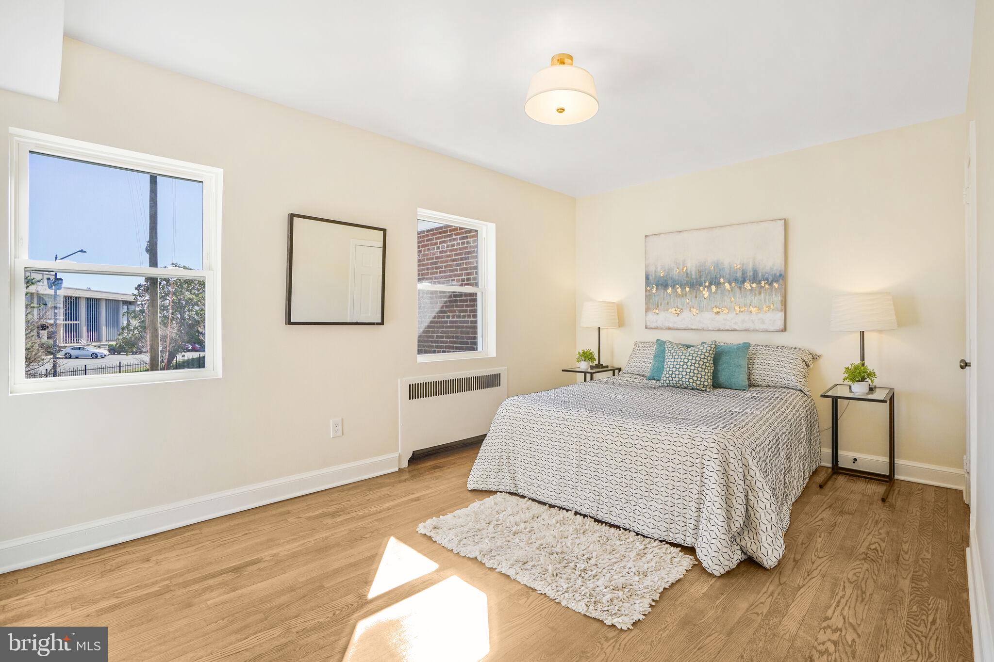 53 Franklin Street Northeast Washington, DC 20002 - Photo 14 of 33 a bedroom with a bed and wooden floor