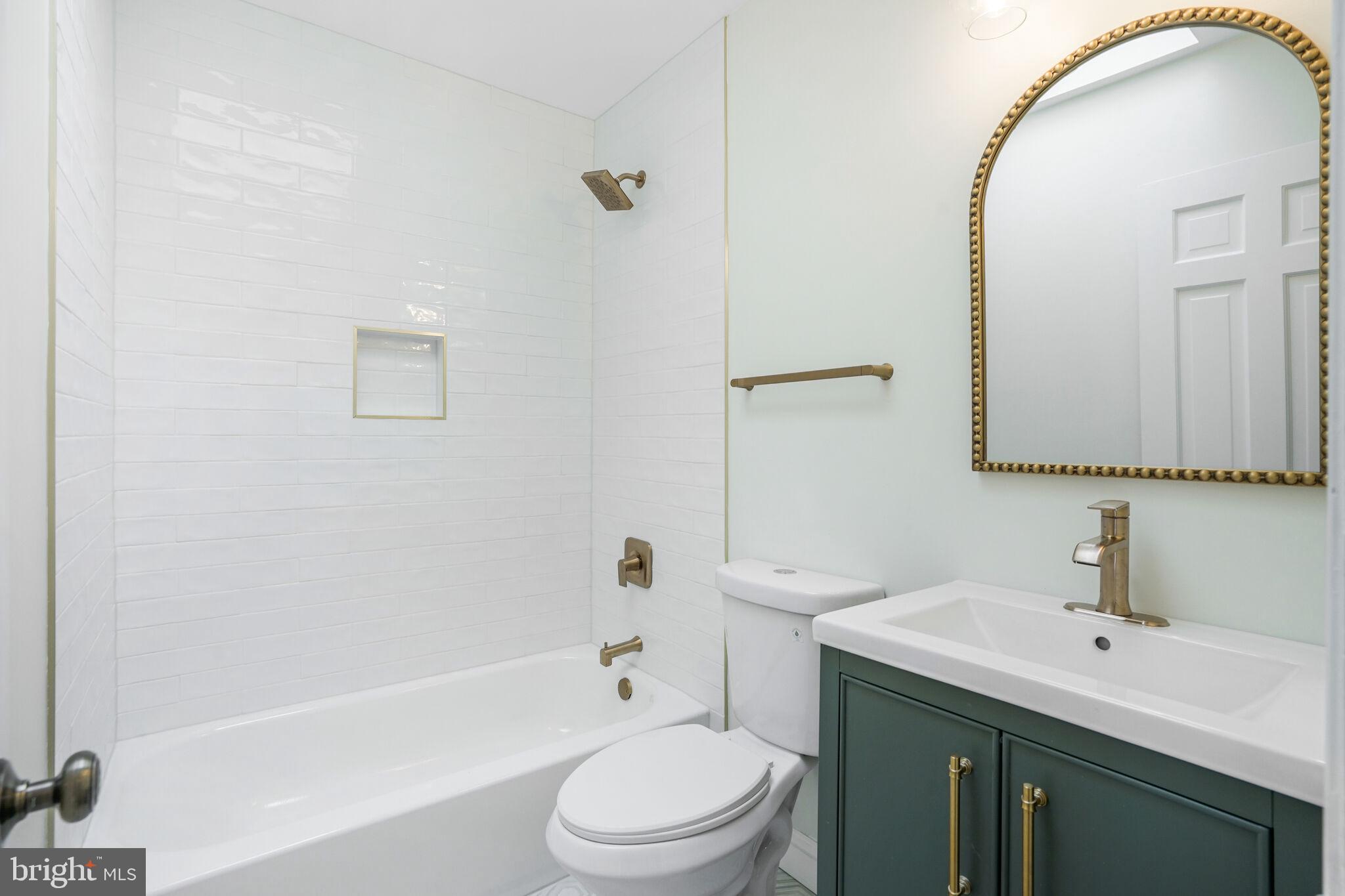 53 Franklin Street Northeast Washington, DC 20002 - Photo 19 of 33 a bathroom with a toilet a sink a mirror and bathtub