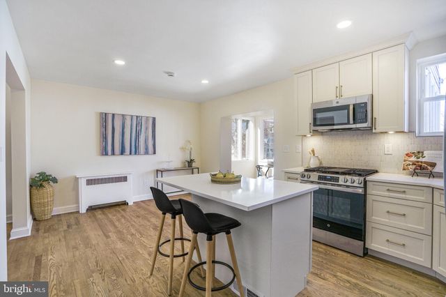 a kitchen with a table and chairs in it