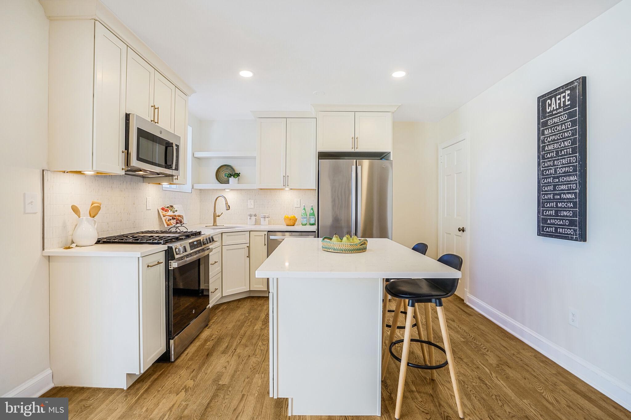 53 Franklin Street Northeast Washington, DC 20002 - Photo 5 of 33 a kitchen with stainless steel appliances granite countertop a stove refrigerator sink and microwave