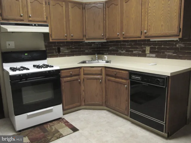 a kitchen with a stove and a sink