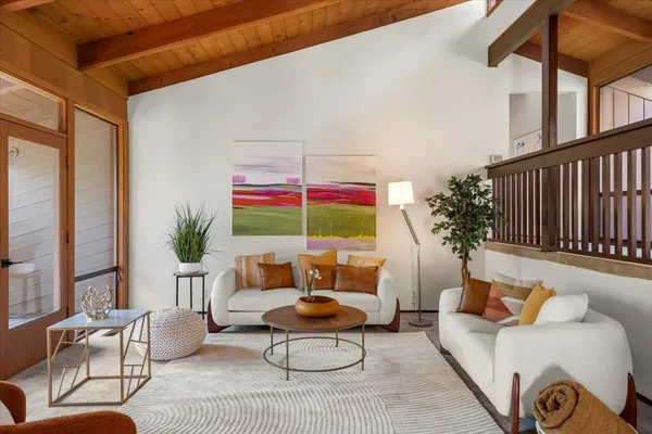 a living room with furniture a rug and a window