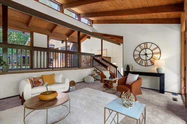 a dining room with furniture a chandelier and wooden floor