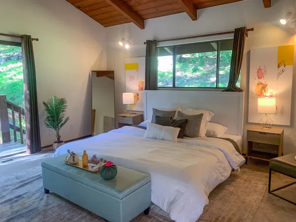 a bedroom with a bed dresser and a large mirror