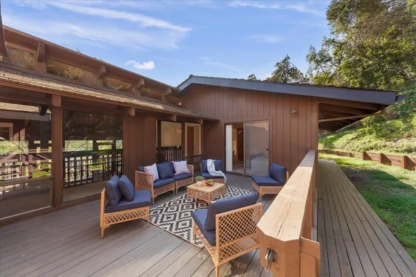 a patio with patio fireplace and couches