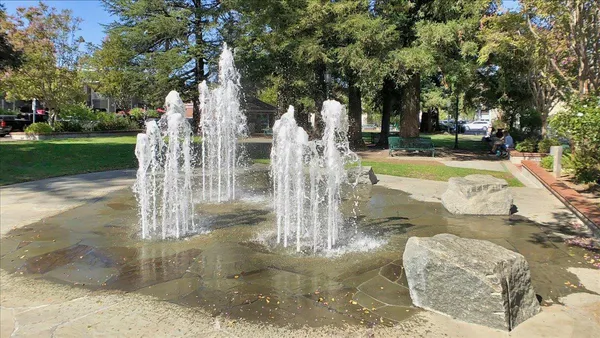 a view of swimming pool with a yard and green space