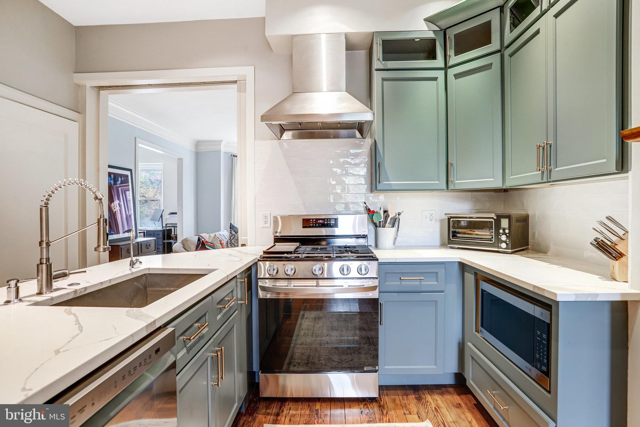 1820 Kalorama Road Northwest, Unit 3 Washington, DC 20009 - Photo 12 of 32 a kitchen with a stove sink and cabinets