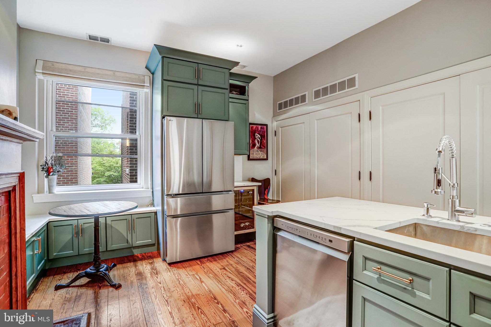 1820 Kalorama Road Northwest, Unit 3 Washington, DC 20009 - Photo 14 of 32 a kitchen with appliances cabinets and a wooden floor