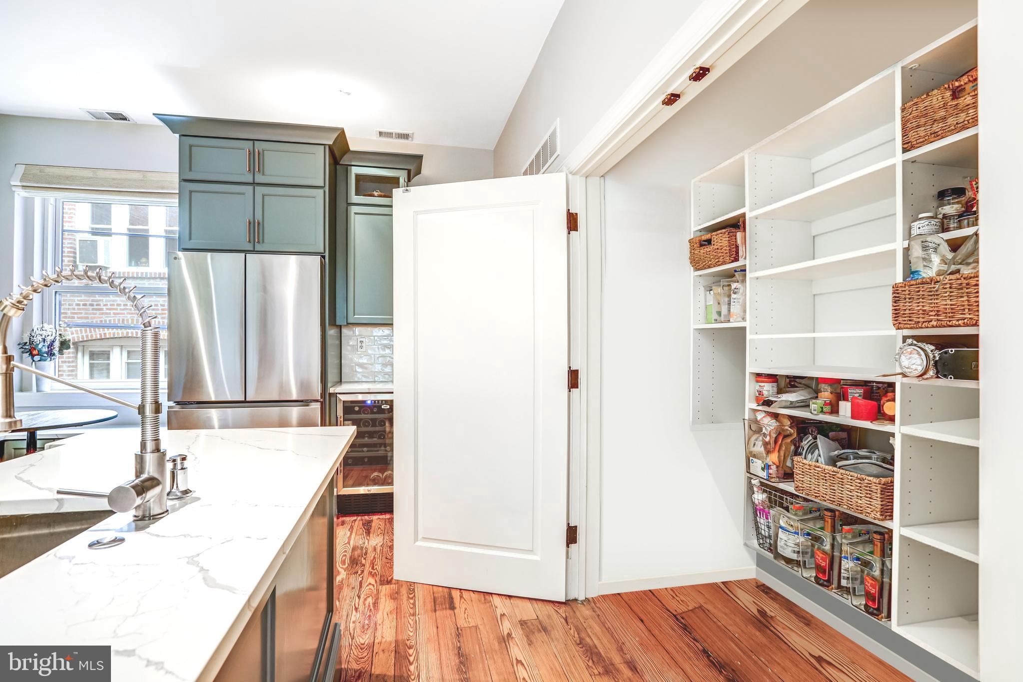 1820 Kalorama Road Northwest, Unit 3 Washington, DC 20009 - Photo 16 of 32 a view of kitchen with stainless steel appliances cabinets and wooden floor