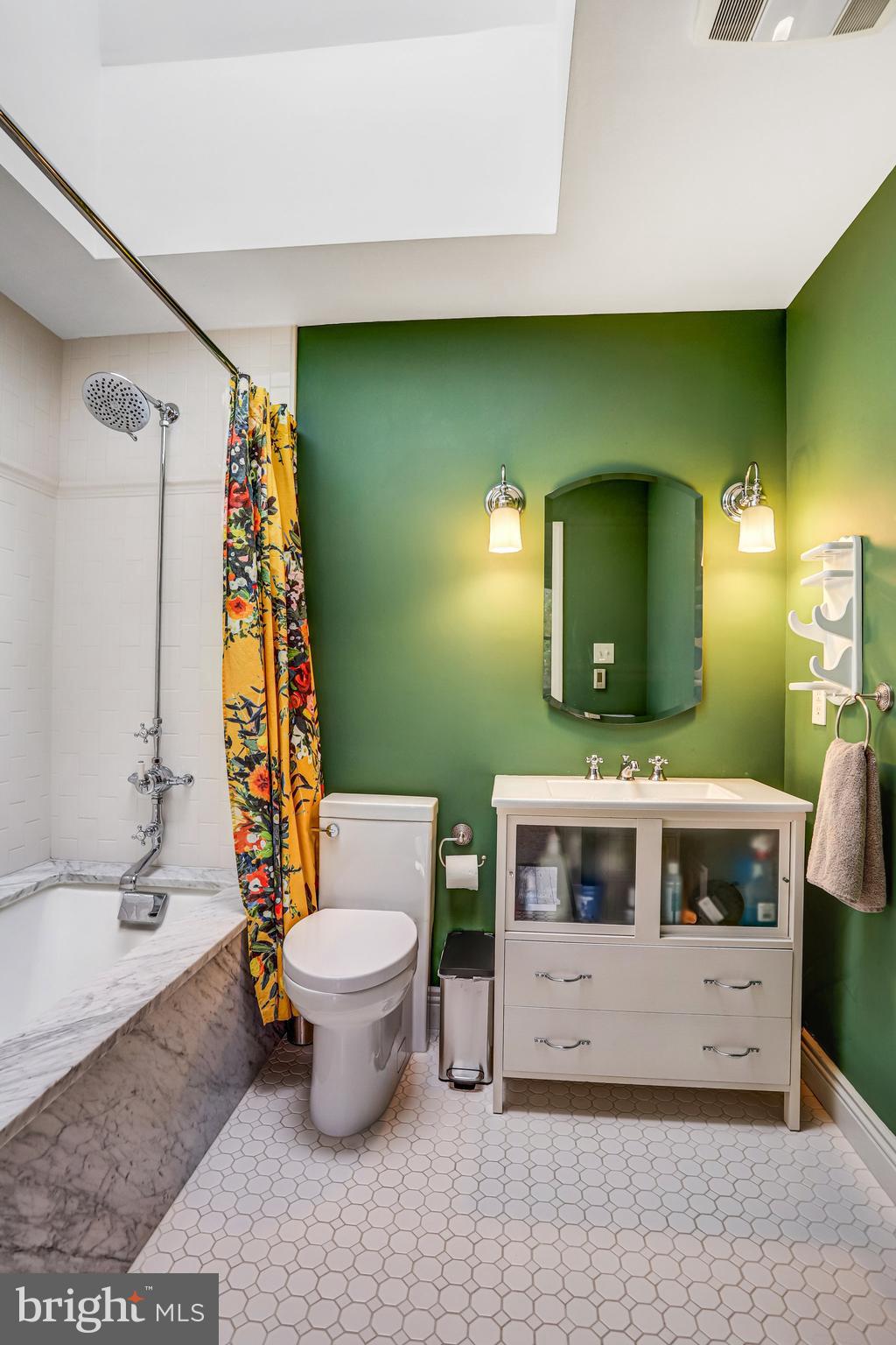 1820 Kalorama Road Northwest, Unit 3 Washington, DC 20009 - Photo 24 of 32 a bathroom with a sink a toilet and a mirror