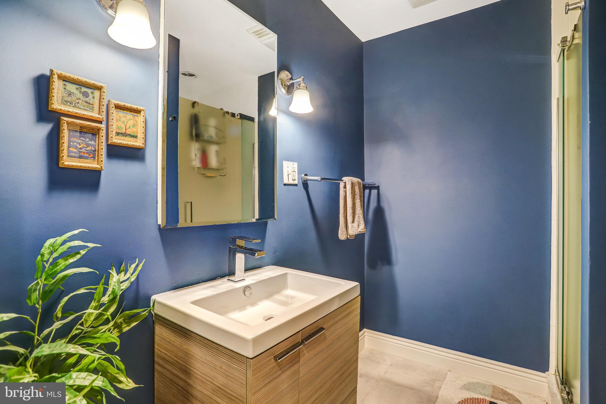 1820 Kalorama Road Northwest, Unit 3 Washington, DC 20009 - Photo 27 of 32 a bathroom with a sink a mirror and a toilet