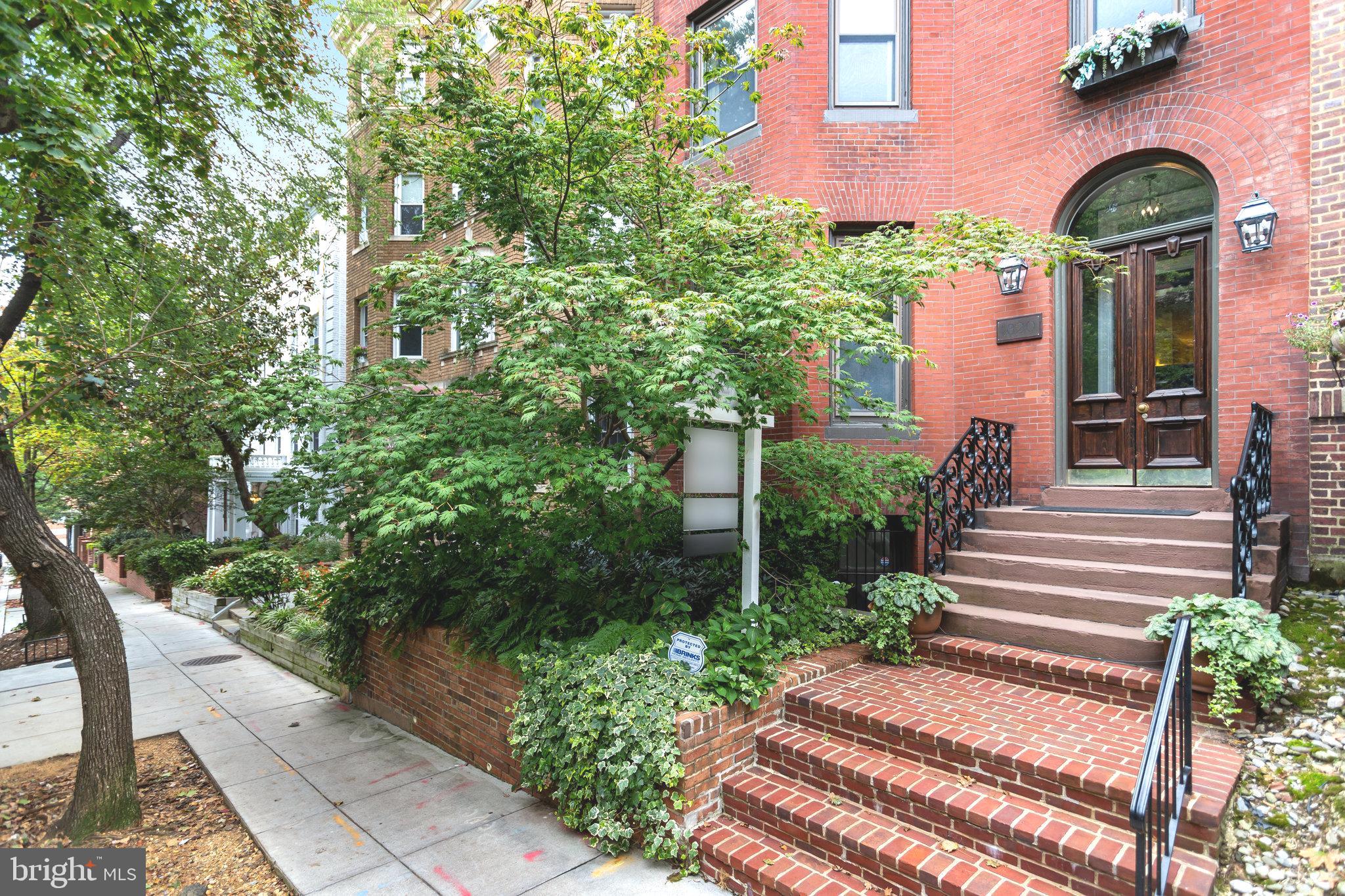 1820 Kalorama Road Northwest, Unit 3 Washington, DC 20009 - Photo 3 of 32 a view of a house with potted plants and a fountain