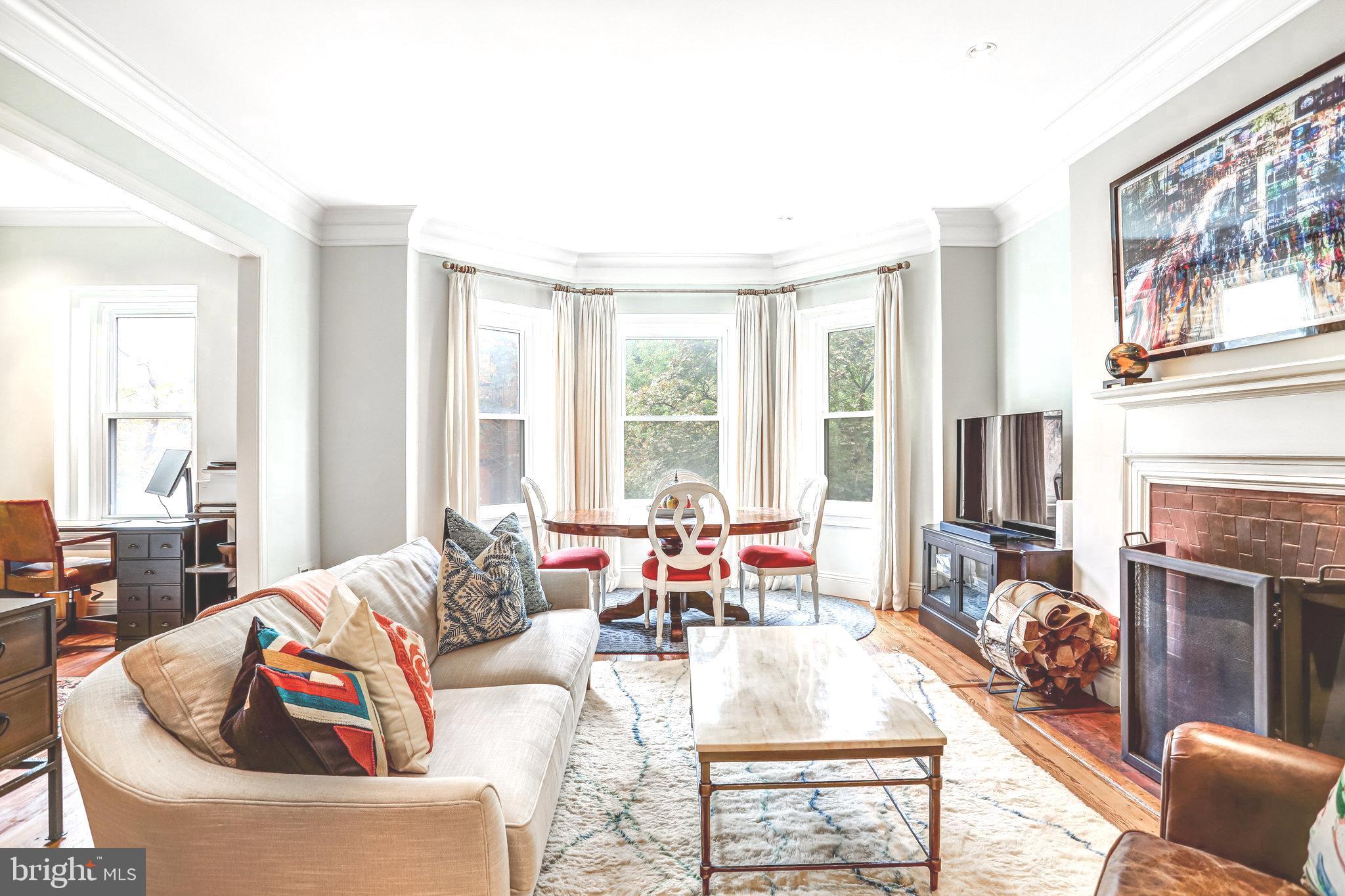 1820 Kalorama Road Northwest, Unit 3 Washington, DC 20009 - Photo 5 of 32 a living room with fireplace furniture and a large window