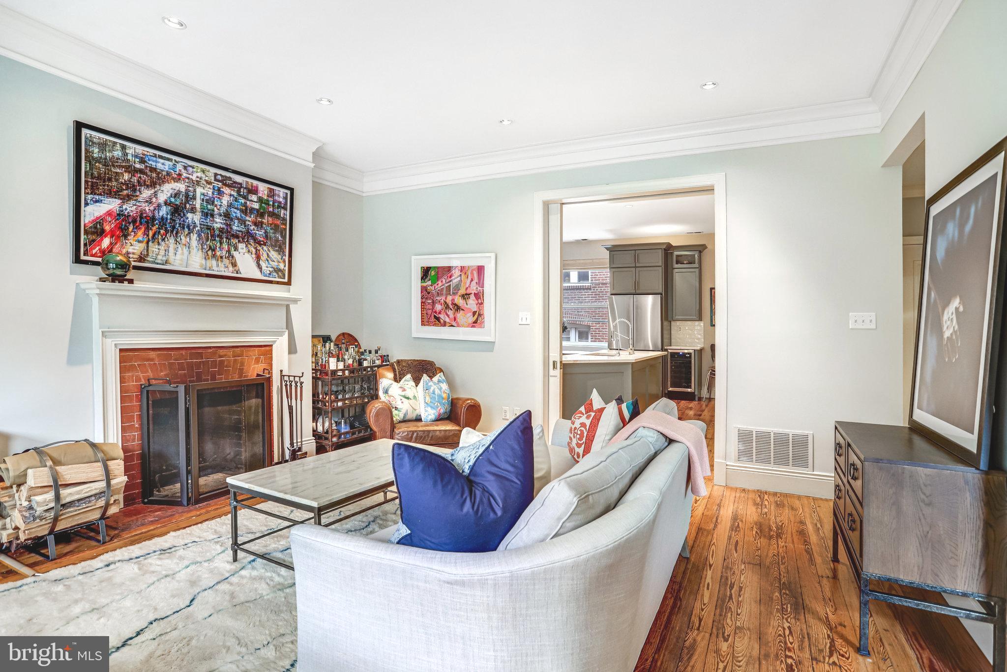 1820 Kalorama Road Northwest, Unit 3 Washington, DC 20009 - Photo 6 of 32 a living room with furniture a fireplace and a flat screen tv